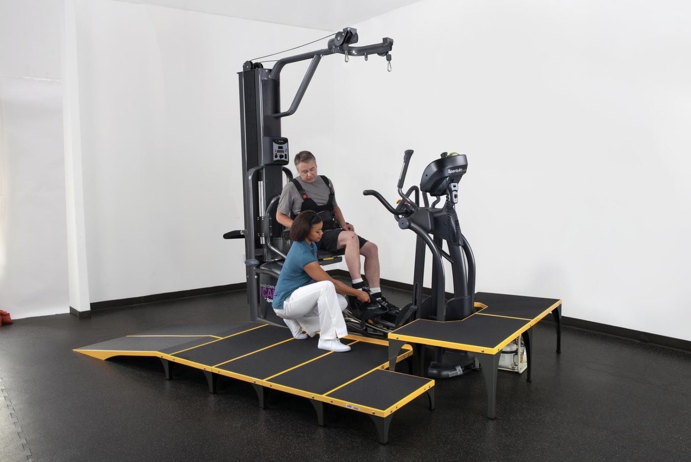 SportsArt ICARE — therapist securing the patient's foot in the pedal restraint