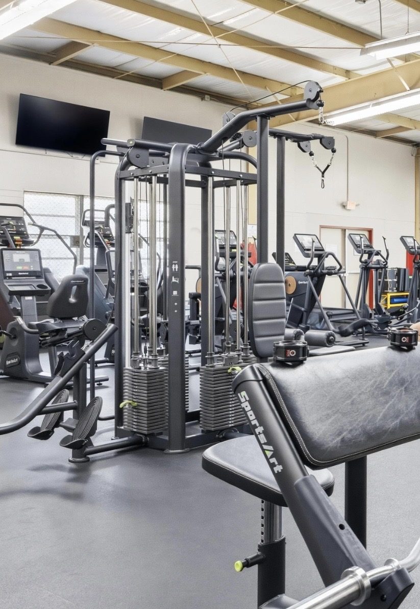 SportsArt commercial fitness equipment — Multi-station cable tower with dual weight stacks — a full strength fl