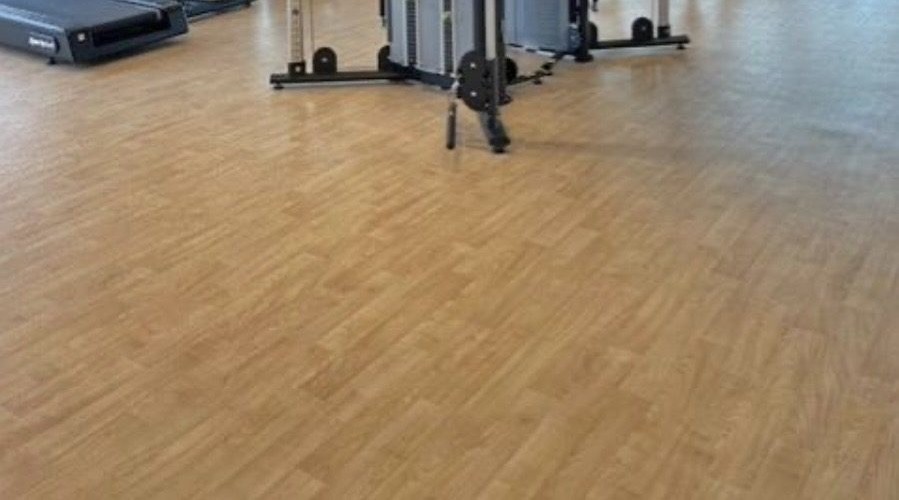 Light wood-look resilient flooring in a fitness room