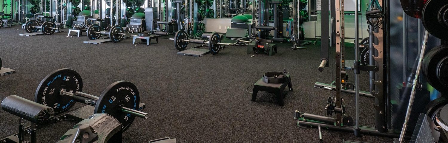 Dark flecked rubber flooring across a commercial training floor